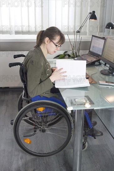 Young woman in a wheelchair at her workplace, Berlin, 18/01/2017