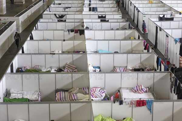 Temporary rooms with beds are set up in an emergency shelter for refugees on 9 December 2015 in a