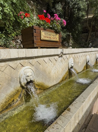 Partial view of lion fountain Venetian fountain Kefalovrisi with 25 waterspouts in the shape of