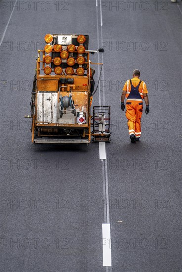 Marking work after the application of new whisper asphalt surface for the A40 motorway, in the