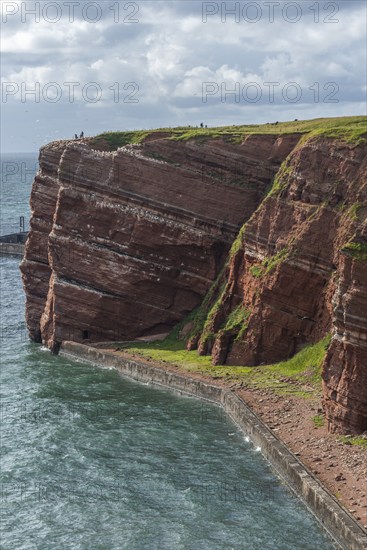 Red coloured sandstone, steep cliff coast of the offshore island of Heligoland, home of the