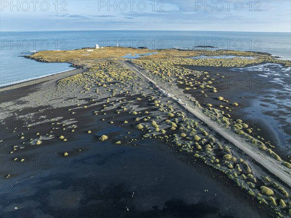 Aerial view of black lava beach, lighthouse and NATO radar station, Stokksnes, east of Höfn, East