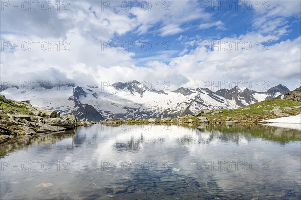 Picturesque mountain landscape with mountain lake, mountains and glaciers reflected in the