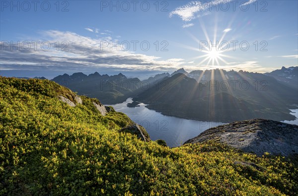 View of Fjord Raftsund and mountains in the evening light, sun star, view from the top of