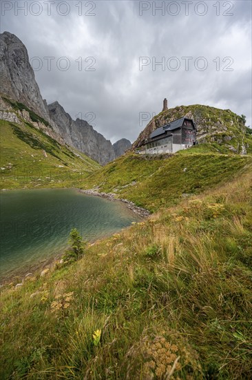 Wolayersee and Alpine Club hut Wolayerseehütte, rocky cloudy mountains, Carnic Alps, Carnic High