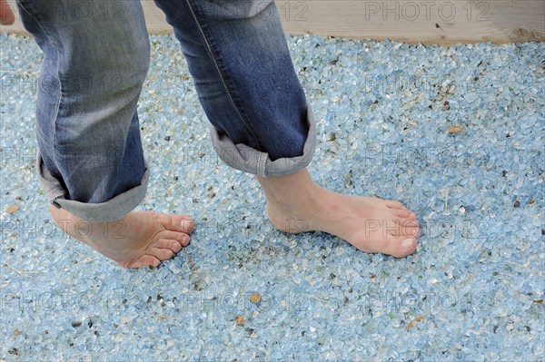Woman walking barefoot over broken glass, glass gravel barefoot path, Tilbeck Abbey, Havixbeck,