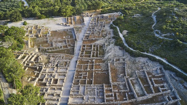Drone shot, first morning light, aerial view of an ancient site, remains of walls and structures