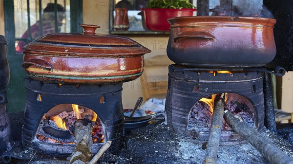 Two pots on open fires in a rustic kitchen, using logs as fuel, Drakona, Slowfood, Restaurant