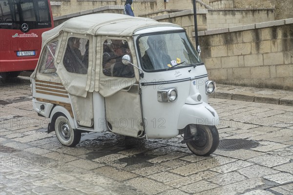 Three-wheeled scooter Ape by Piaggio in a street in Matera, Basilicata, Southern Italy, Italy,