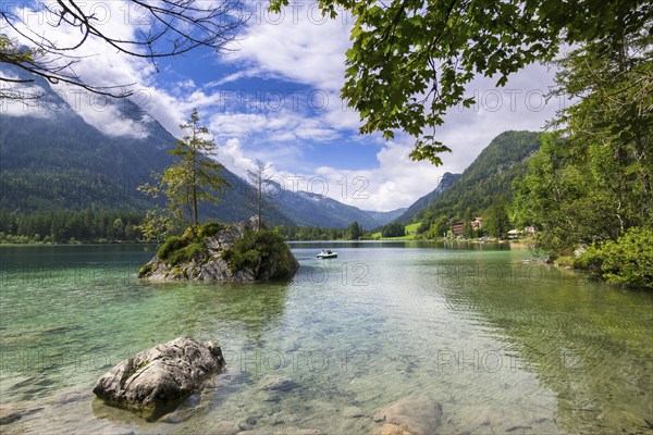 Hintersee near Ramsau with clear green water, surrounded by forests and mountains under a cloudy