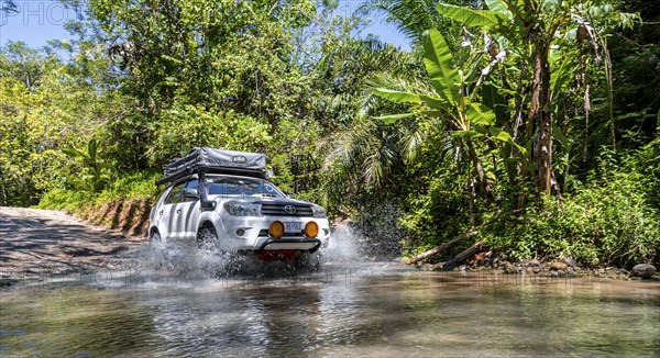 4x4 car drives through a river, water crossing with the off-road car, Costa Rica, Central America