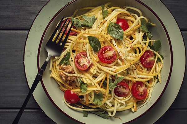 Yellow zucchini salad, with cherry, vegetarian food, sliced into strips, homemade