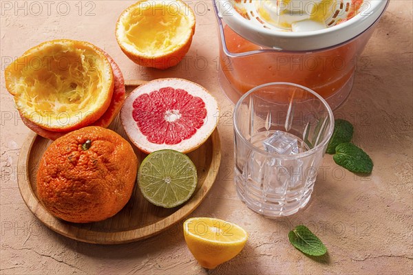 Citrus juicer, sliced fruit, glass with ice, close-up, no people, breakfast