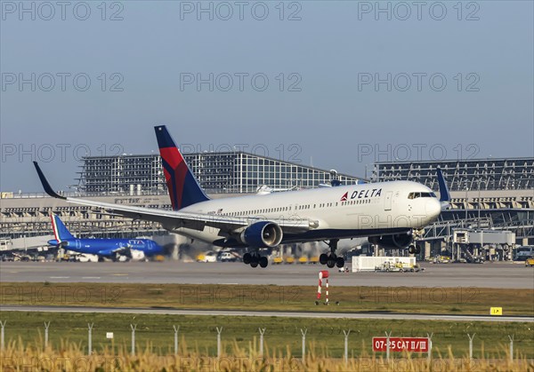Stuttgart Airport with terminal, Delta Air Lines aircraft landing. Boeing 767-300. Stuttgart