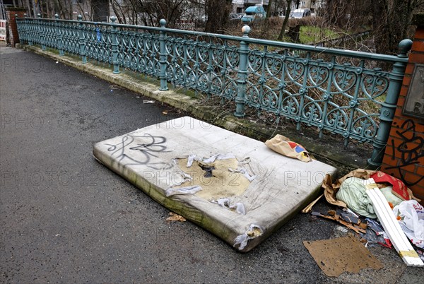 A mattress lying on a pavement, illegal waste disposal in the Berlin district of Wedding,