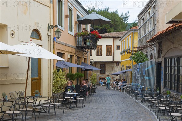 Cosy street café with guests and parasols on an old cobbled street, Xanthi, Eastern Macedonia and