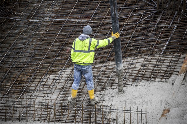 Construction site, concreting, the foundation of a building is concreted, the concrete is pumped