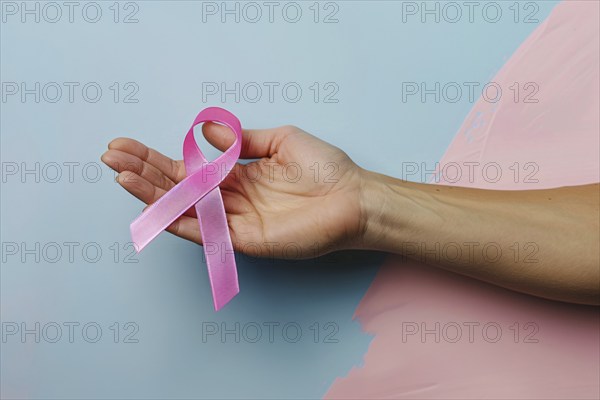 Woman's hand holding pink breast cancer awareness ribbon. Generative AI, AI generated