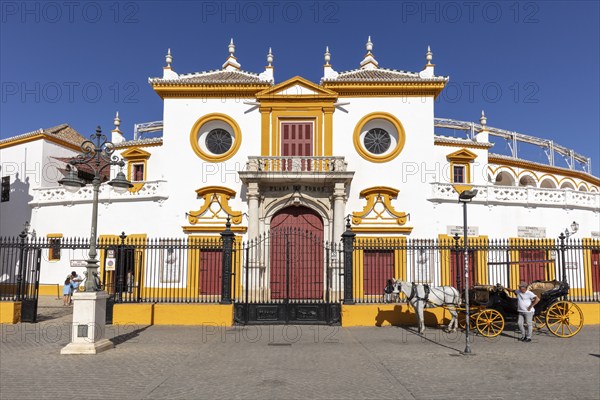 Facade of the Spanish-style bullring with carriage in the foreground, Seville