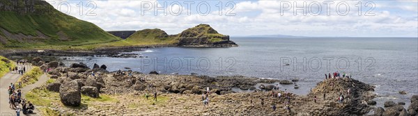 Panoramic view of coast with basalt columns, cliffs and sea under a cloudy sky, Giant Causeway