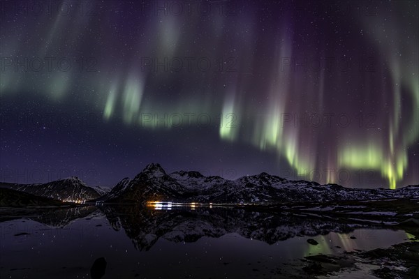 Northern lights over fjord, steep mountains, winter, aurora borealis, Flakstadoya, Lofoten, Norway,