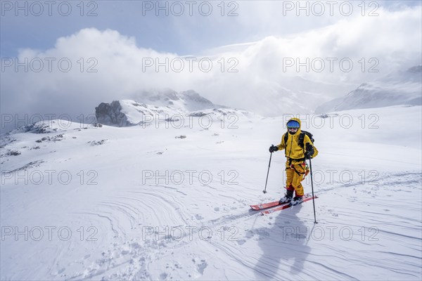 Ski tourers in a snowy mountain landscape, ascent to the Wildhorn, cloudy mood, high tour, Bernese