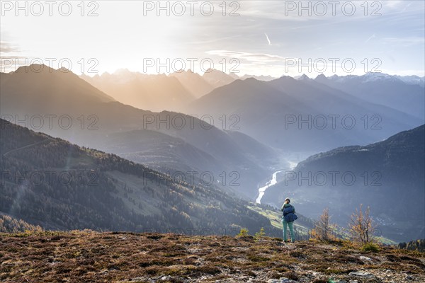 Hiker on the Venet, Upper Inn Valley in the morning light, view from Venet, Ötztal Alps, Tyrol,