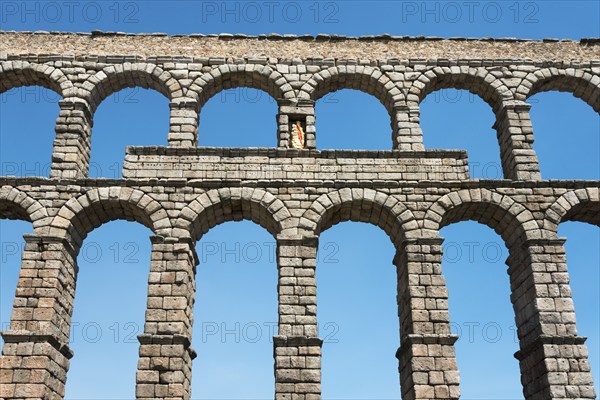 Ancient stone aqueduct with several arches in front of a blue sky, Aqueduct, Segovia, Castilla y