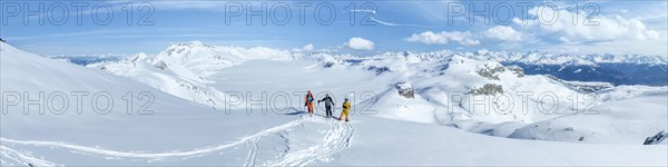 Three ski tourers in front of a snow-covered glacier plain, Plaine Morte Glacier, Bernese Alps,