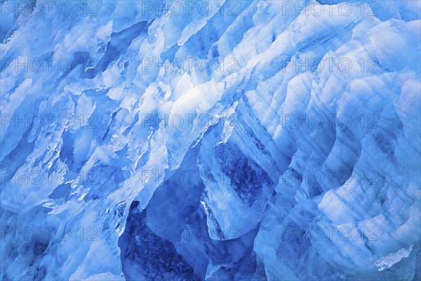 Blue ice patterns on a glacier wall in the arctic, Svalbard, Norway, Europe