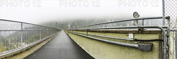 View of the path on the dam wall of the Zufritt reservoir, power station, hydroelectric power plant