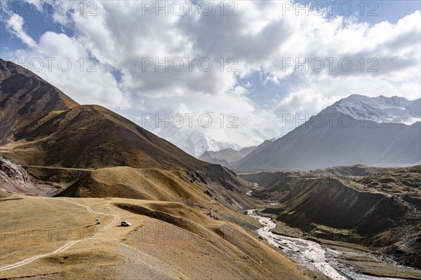 Achik Tash river, Achik Tash valley, behind glaciated and snow-covered mountain peak Pik Lenin,