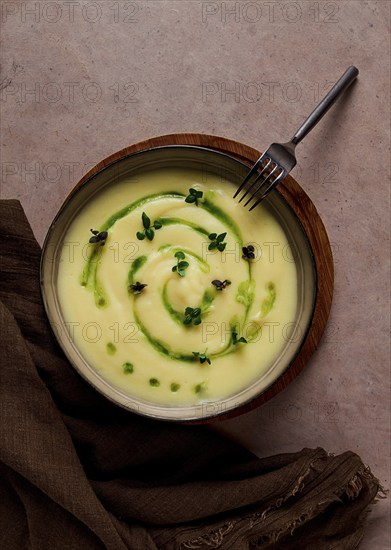 Mashed potatoes, with green butter and micro greenery, homemade, on a beige table, no people, top