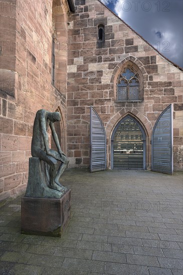 Main entrance of St Clare's Church, on the left the bronze sculpture of Job, created by the German