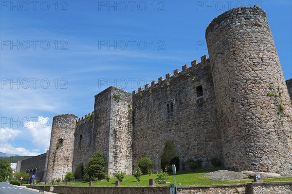 Massive medieval castle wall with stone towers under a clear blue sky, Castle, Castillo de la