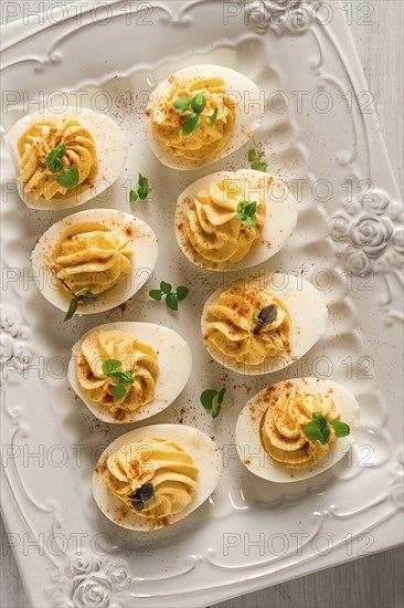 Boiled eggs stuffed with yolk with mayonnaise, on a white plate, selective focus, blurry, close-up,