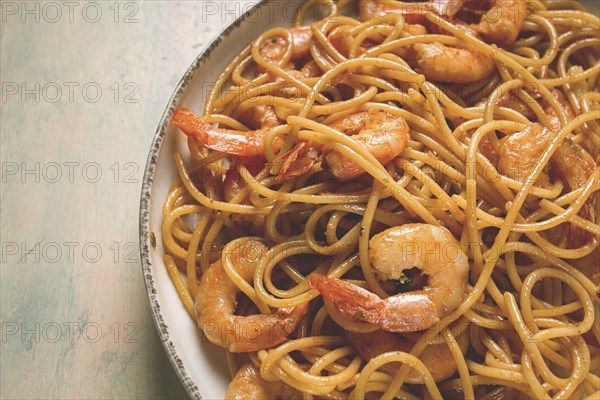 Spaghetti with king shrimps, with spices, top view, selective focus, homemade, no people
