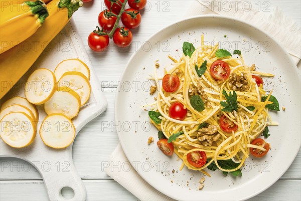 Yellow zucchini salad, with cherry, vegetarian food, sliced into strips, homemade