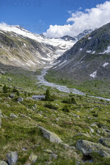 Picturesque mountain landscape, behind mountain peak with snow and glacier Hornkees, valley with