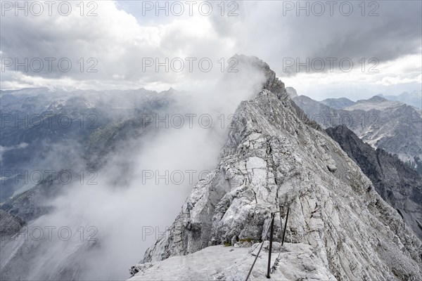 Clouds around a narrow rocky ridge, Watzmann crossing to Watzmann Mittelspitze, view of mountain