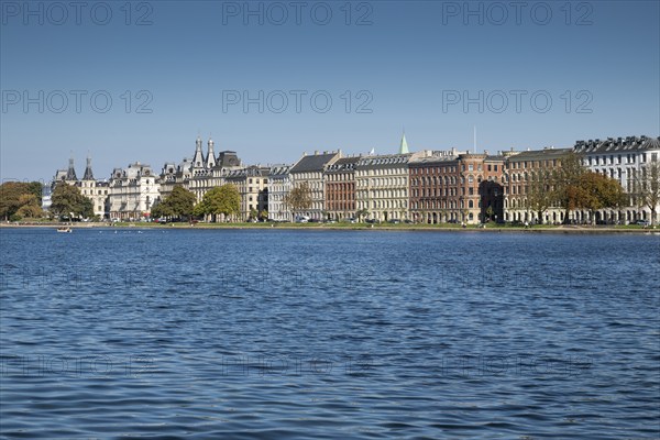 Historic buildings on the waterfront under a blue sky, Søerne, Sortedams Sø, Copenhagen Lakes,