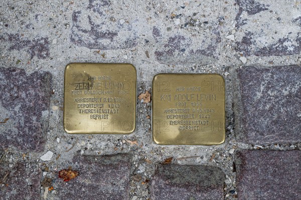 Two Stumbling Stones embedded in the pavement as memorials against forgetting the injustice of