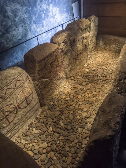 Carved figures in stone slabs inside the King's Tomb, a Bronze Age tomb in Kivik, Simrishamn