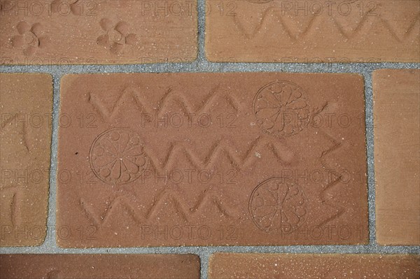 Brick kiln with zigzag design and circular patterns, on a tiled floor, Patmos Cotto Brickworks,