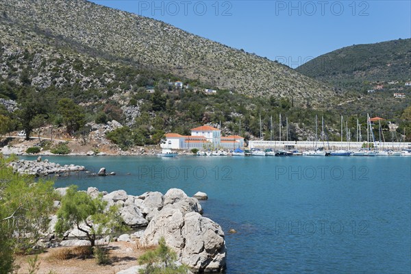 Harbour with boats in front of a picturesque mountainous landscape by the sea, harbour of Methana,