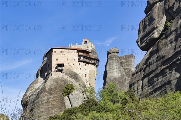 Monastery of St Nikolaos Anapavsas on a rock, sandstone formation, Meteora, blue sky, spring