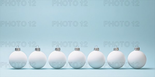 White Christmas tree baubles in a row on pastel blue background. Generative AI, AI generated