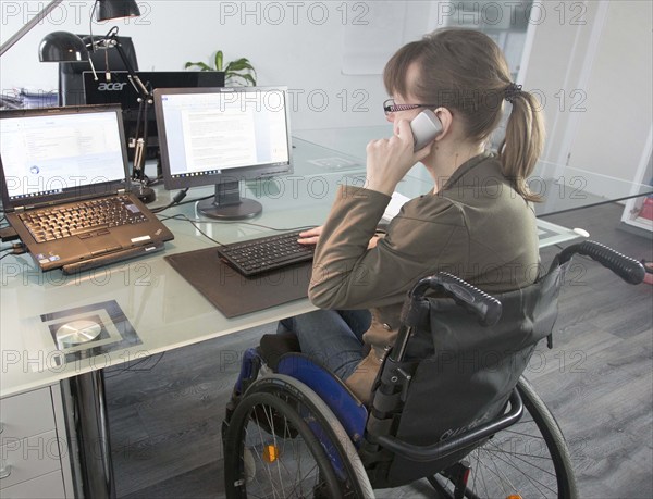 Young woman in a wheelchair at her workplace, Berlin, 18/01/2017