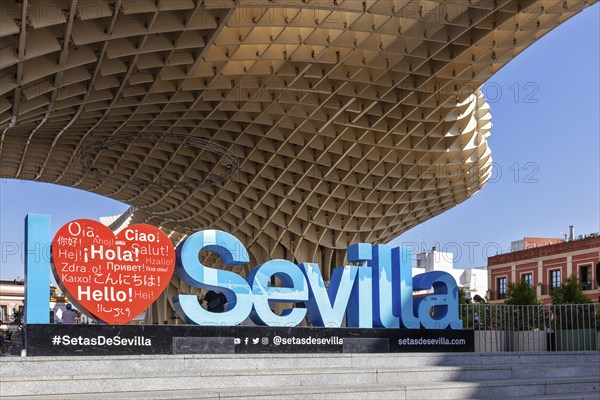Welcome sign in various languages in front of the imposing architecture of the Metropol Parasol,
