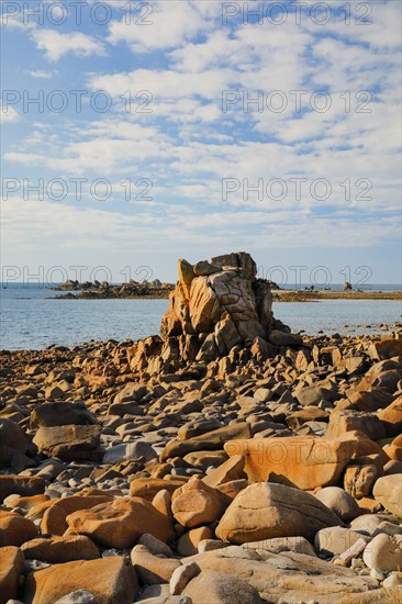 Striking orange-coloured rock formations in the evening light, on the coast of the English Channel